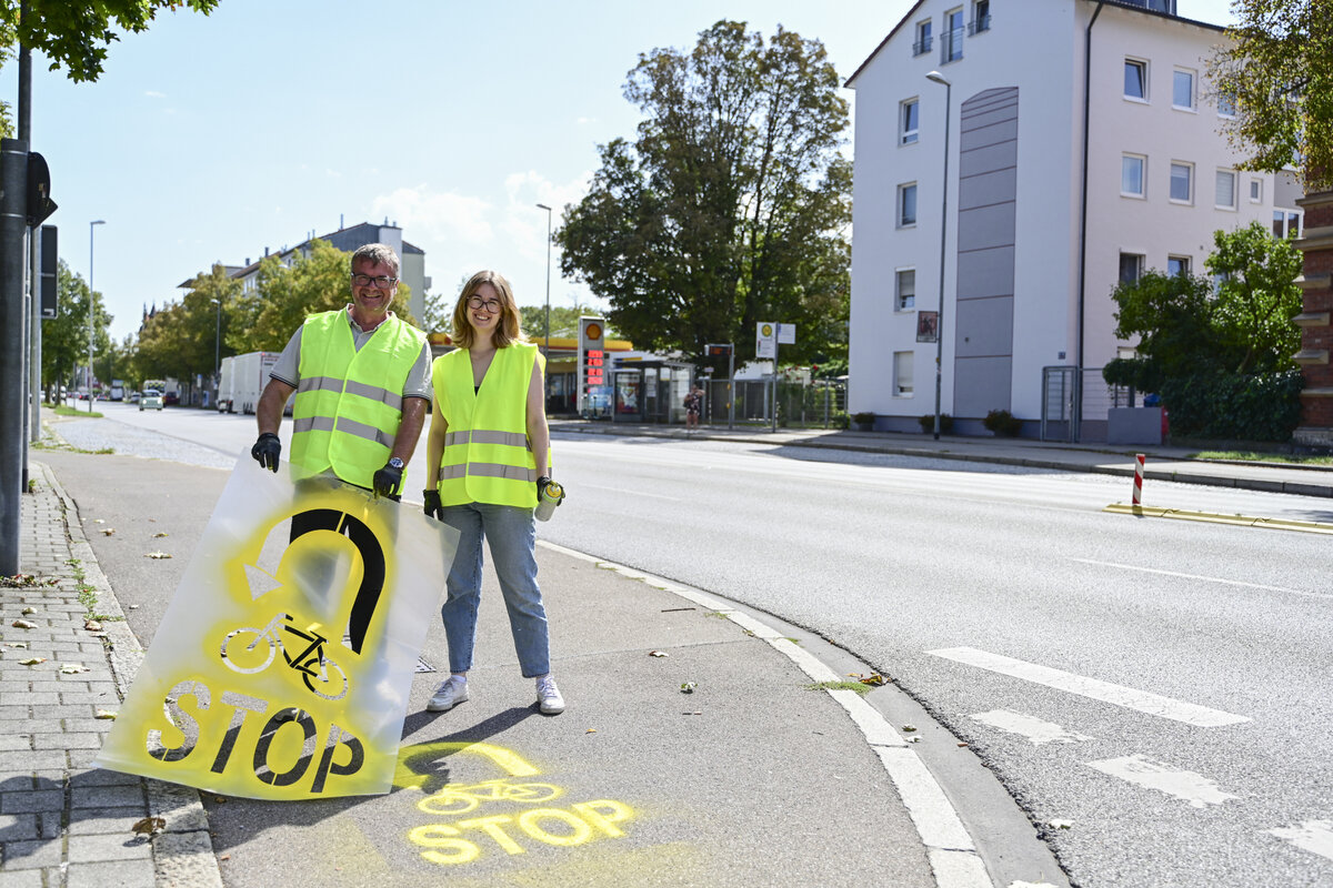 Fahrradbeauftragte Theresa Schneider und Ulrich Sch�pe vom Amt f�r Verkehrsmanagement und Geoinformation bringen Hinweise auf dem Fahrradweg auf. 